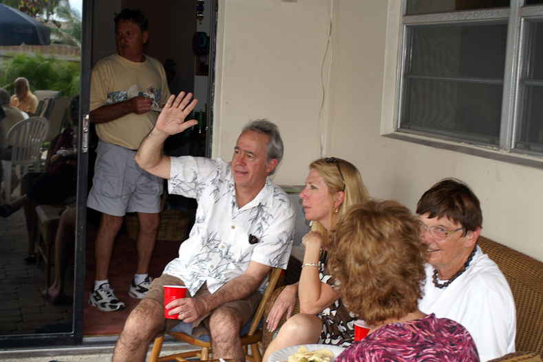 Donald waving and sitting next to Phil and her mom.  Mike's in the doorway.